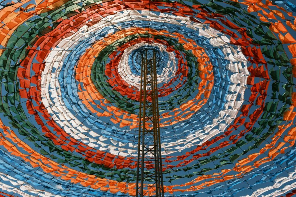 A central tower surrounded by colorful, concentric fabric circles.