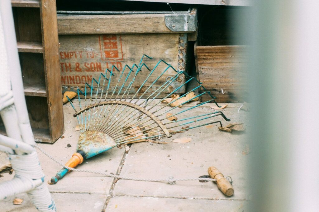 rake on pavement beside box